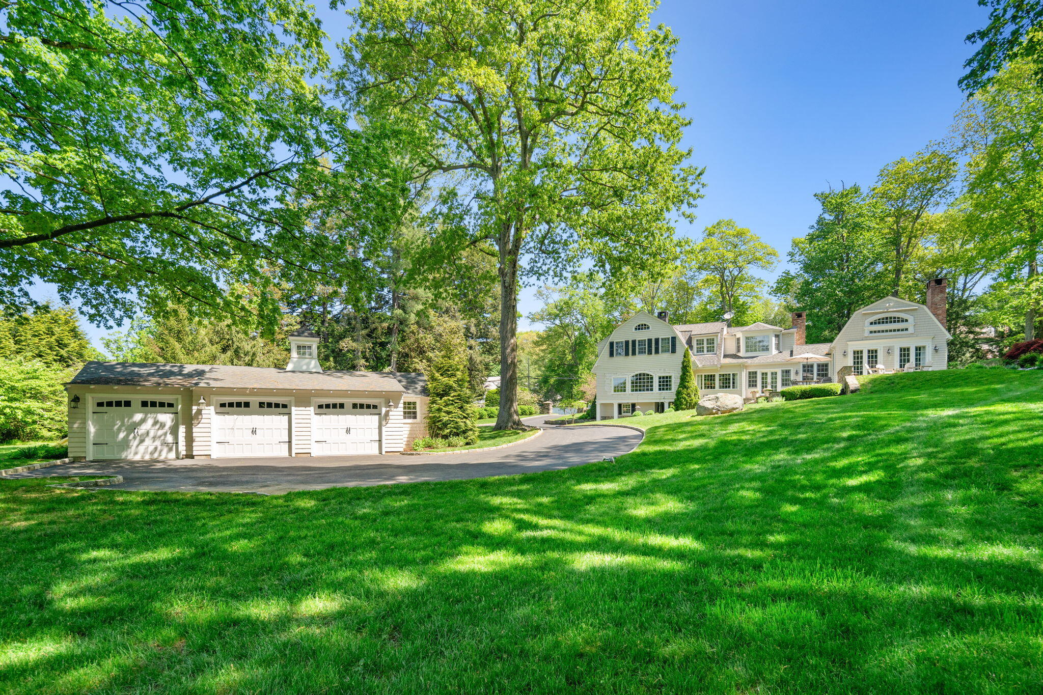 1466 Ponus Ridge Road New Canaan, CT 06840 - Photo 77 of 81 a view of a house with backyard and a sitting area