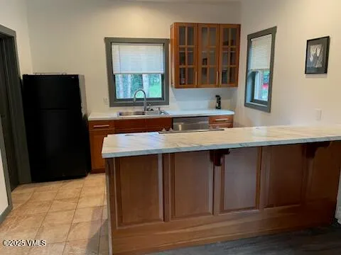 a kitchen with a sink and a refrigerator