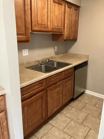 a kitchen with granite countertop a stove and a sink