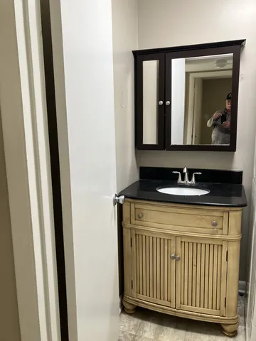a bathroom with a sink a mirror and a window