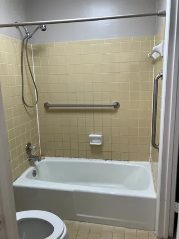 a bathroom with a shower and a tub