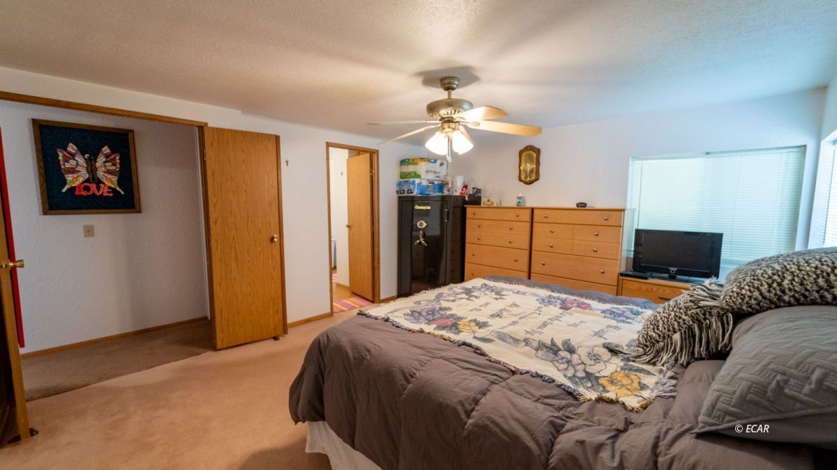 20 Primeaux Canyon Road Eureka, NV 89316 - Photo 7 of 24 a bedroom with a bed and a chandelier