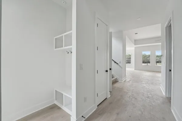 a view of a kitchen with refrigerator and white cabinets