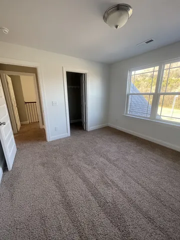 an empty room with windows and entrance