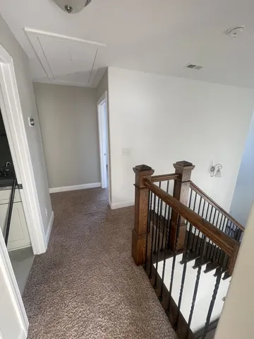 a view of a hallway with furniture