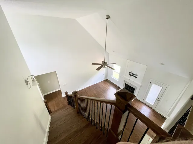 a view of a room with furniture and wooden floor