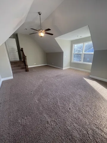 a view of a livingroom with a ceiling fan and window