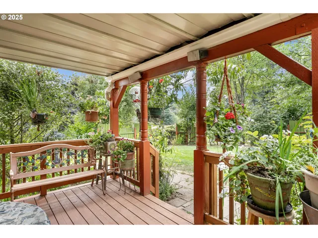 a view of a balcony with wooden floor