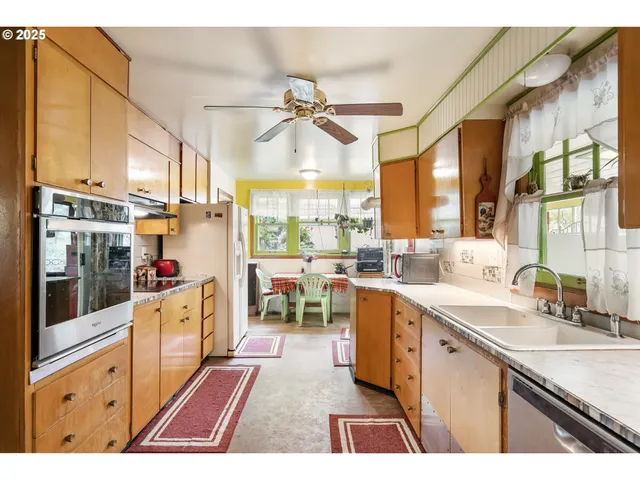 a kitchen with a sink cabinets and window
