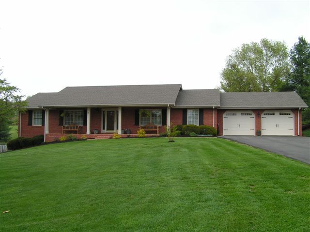 115 Stonebridge Drive Blue Ridge, VA 24064 - Photo 1 of 64 a front view of a house with a garden