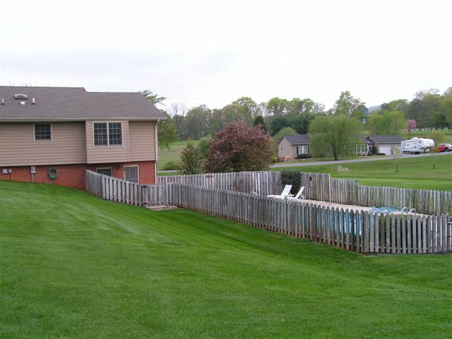 115 Stonebridge Drive Blue Ridge, VA 24064 - Photo 11 of 64 a view of a deck with a yard and wooden fence