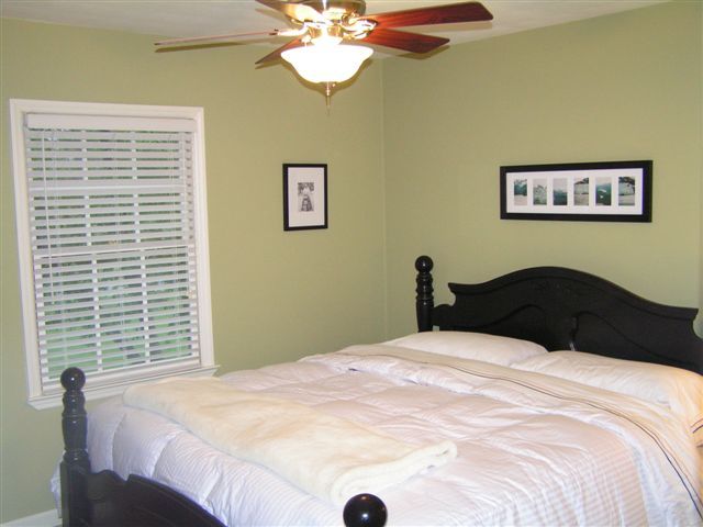 115 Stonebridge Drive Blue Ridge, VA 24064 - Photo 32 of 64 a bedroom with a large bed and a chandelier