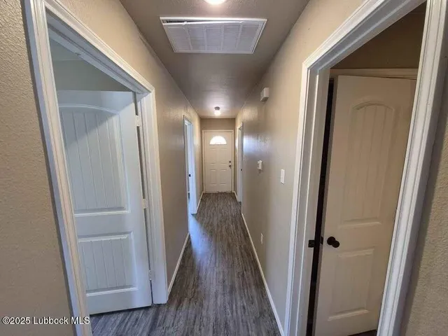 a view of hallway with wooden floor