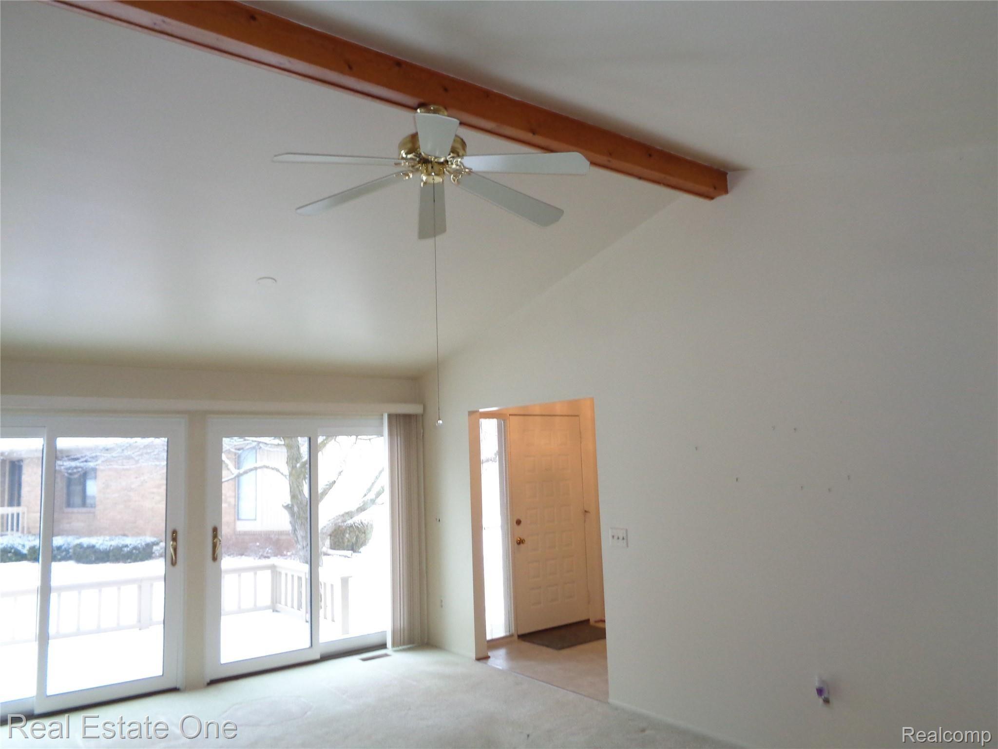 624 Tennyson, Unit 113 Rochester, MI 48307 - Photo 16 of 51 Cathedral ceiling has wood beam for character, clean palette.