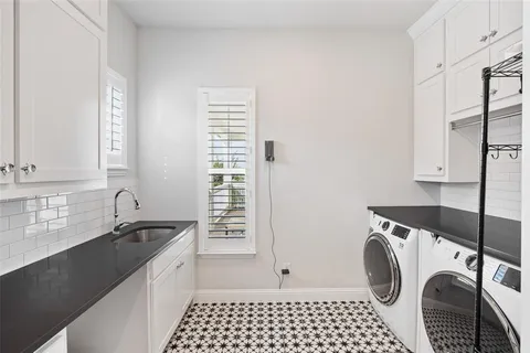 a kitchen with a sink a washer and dryer