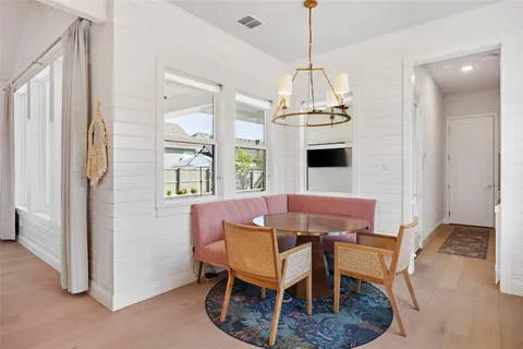 a dining room with furniture a chandelier and window