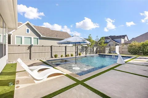 a view of a house with pool and chairs