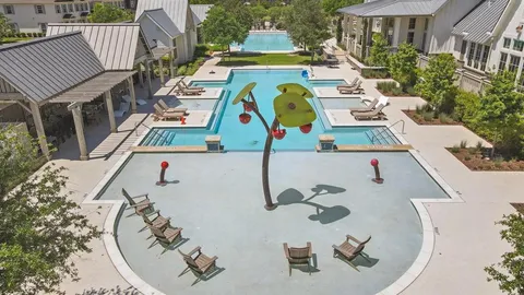 an aerial view of a house with swimming pool patio and outdoor seating