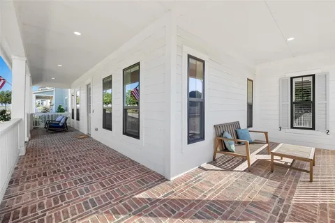 a bedroom with furniture and large windows