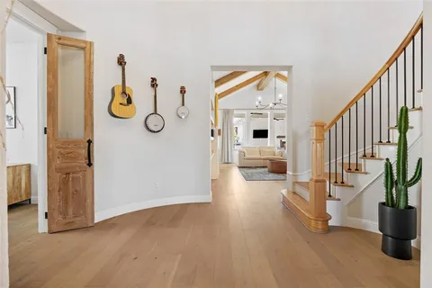 a view of an entryway with wooden floor