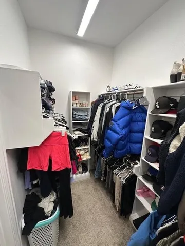 a spacious bedroom with a bed and a ceiling fan