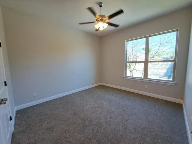 a spacious bathroom with a granite countertop sink and a mirror