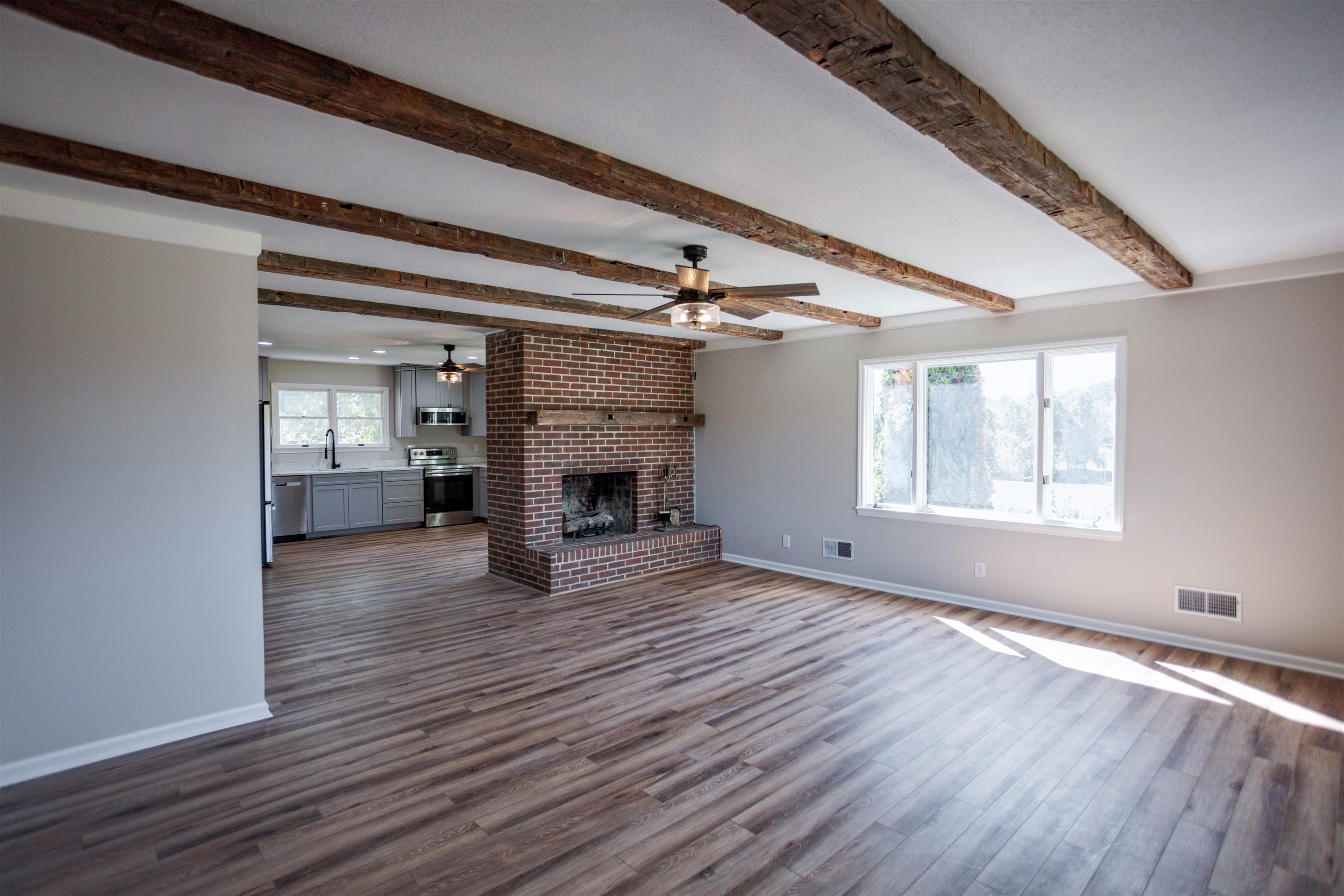2834 Brownsburg Turnpike Raphine, VA 24472 - Photo 13 of 38 a view of empty room with wooden floor and fireplace