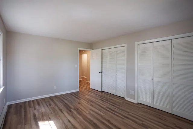 a view of an empty room and wooden floor