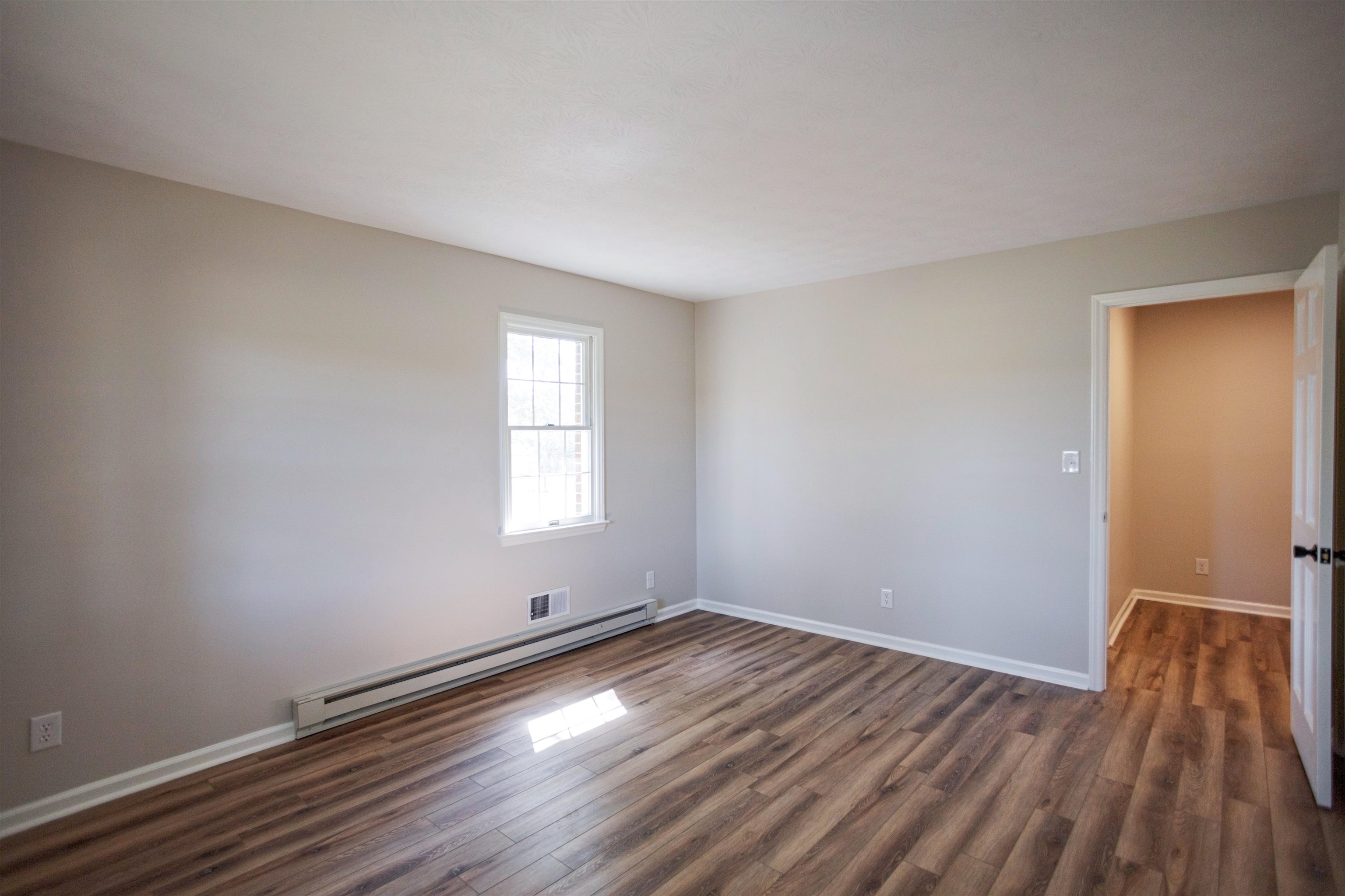 2834 Brownsburg Turnpike Raphine, VA 24472 - Photo 18 of 38 an empty room with wooden floor and windows