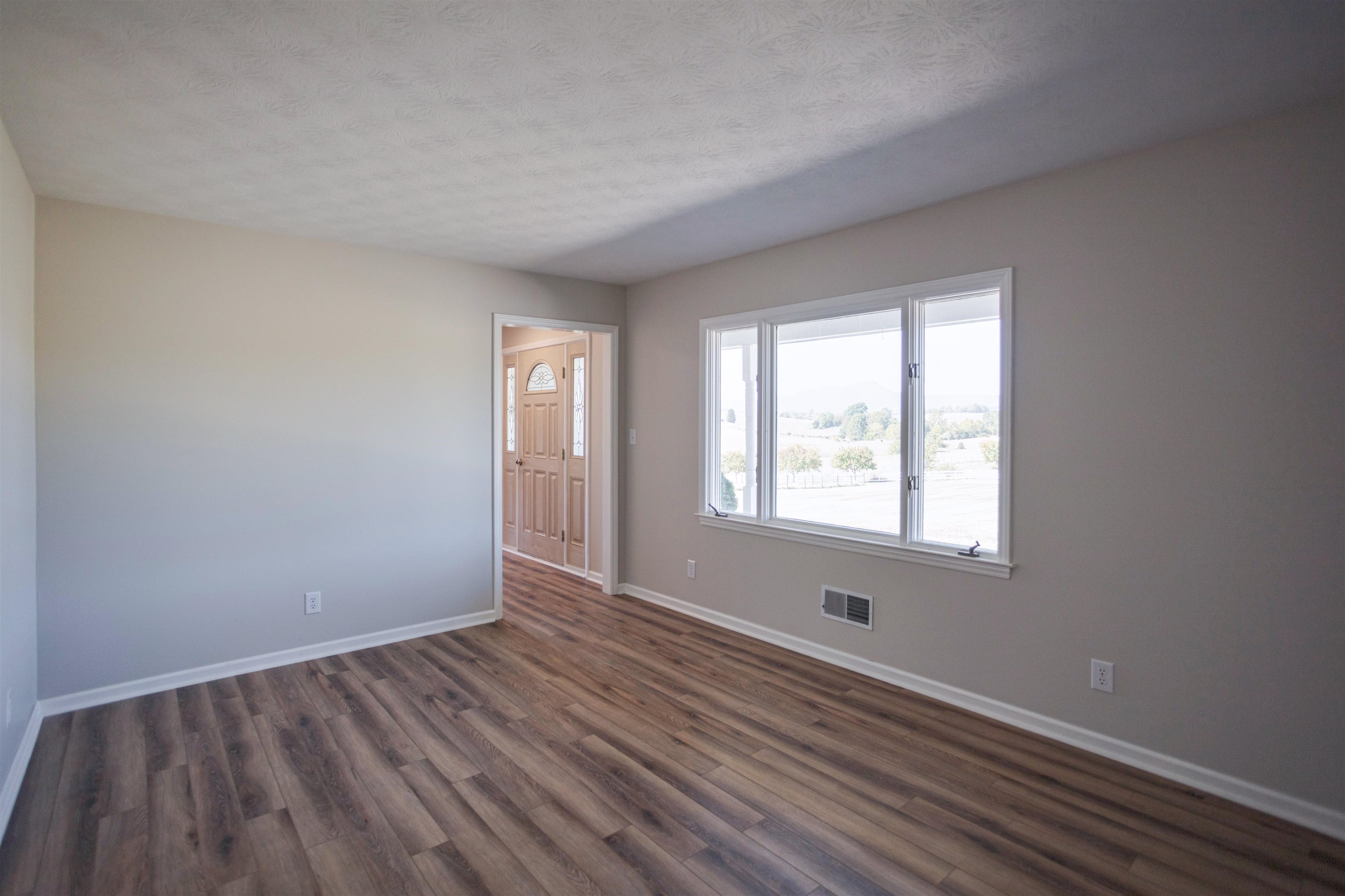 2834 Brownsburg Turnpike Raphine, VA 24472 - Photo 23 of 69 a view of an empty room with wooden floor and a window