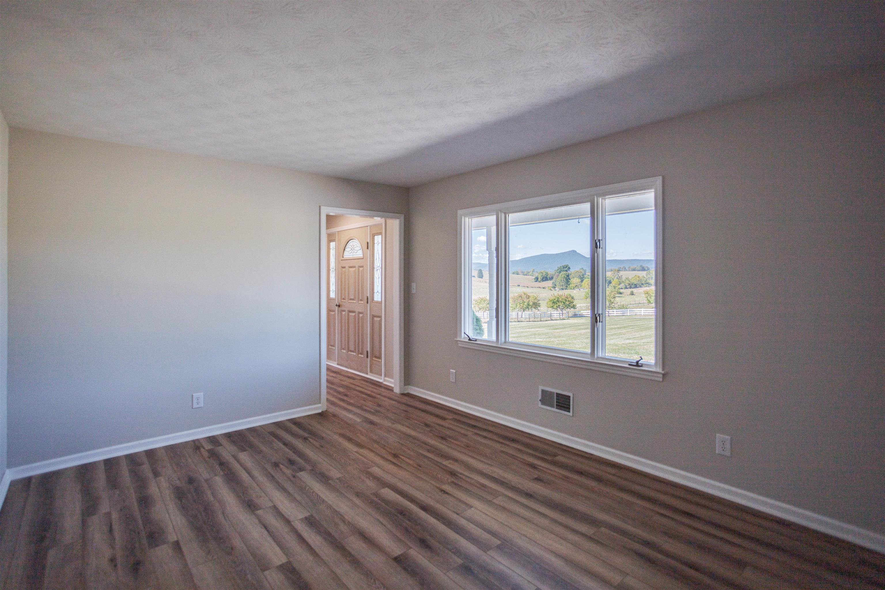 2834 Brownsburg Turnpike Raphine, VA 24472 - Photo 24 of 69 a view of an empty room with wooden floor and a window
