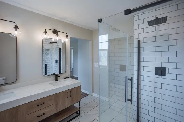 a bathroom with a double vanity sink and a mirror