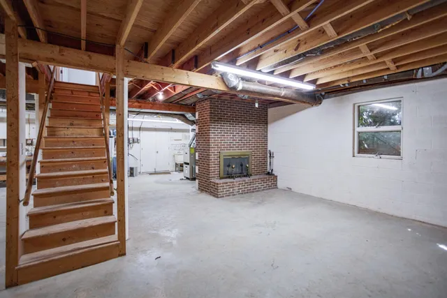 a view of an empty room with a fireplace