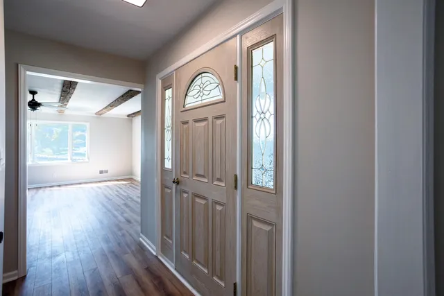 a view of a hallway with wooden floor