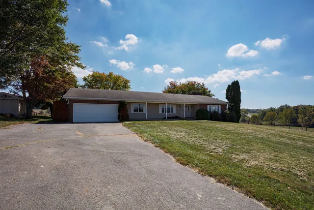 a front view of a house with a yard and a garage