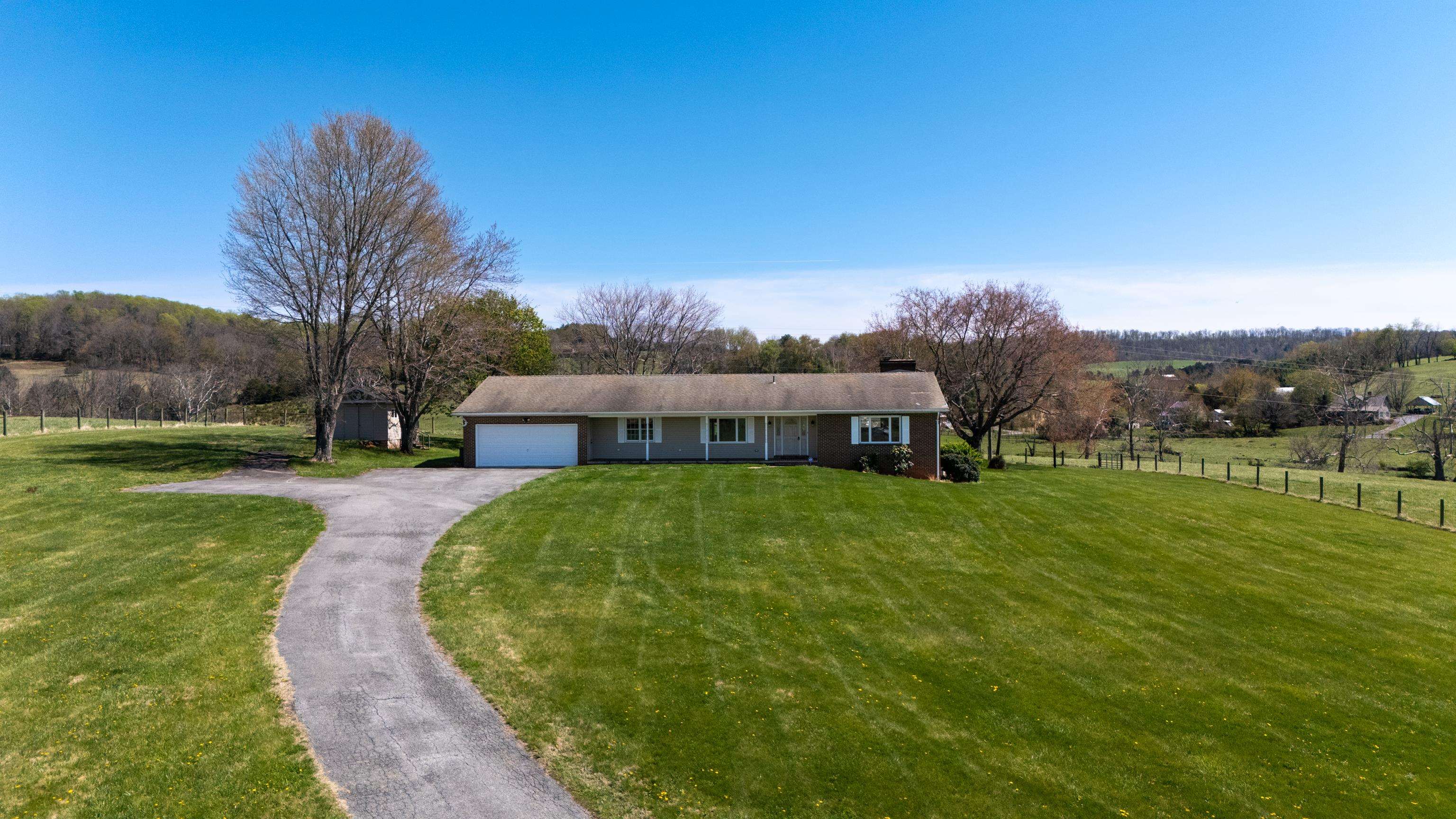 2834 Brownsburg Turnpike Raphine, VA 24472 - Photo 49 of 69 a front view of a house with a garden and yard