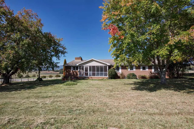 a house that has a tree in front of it