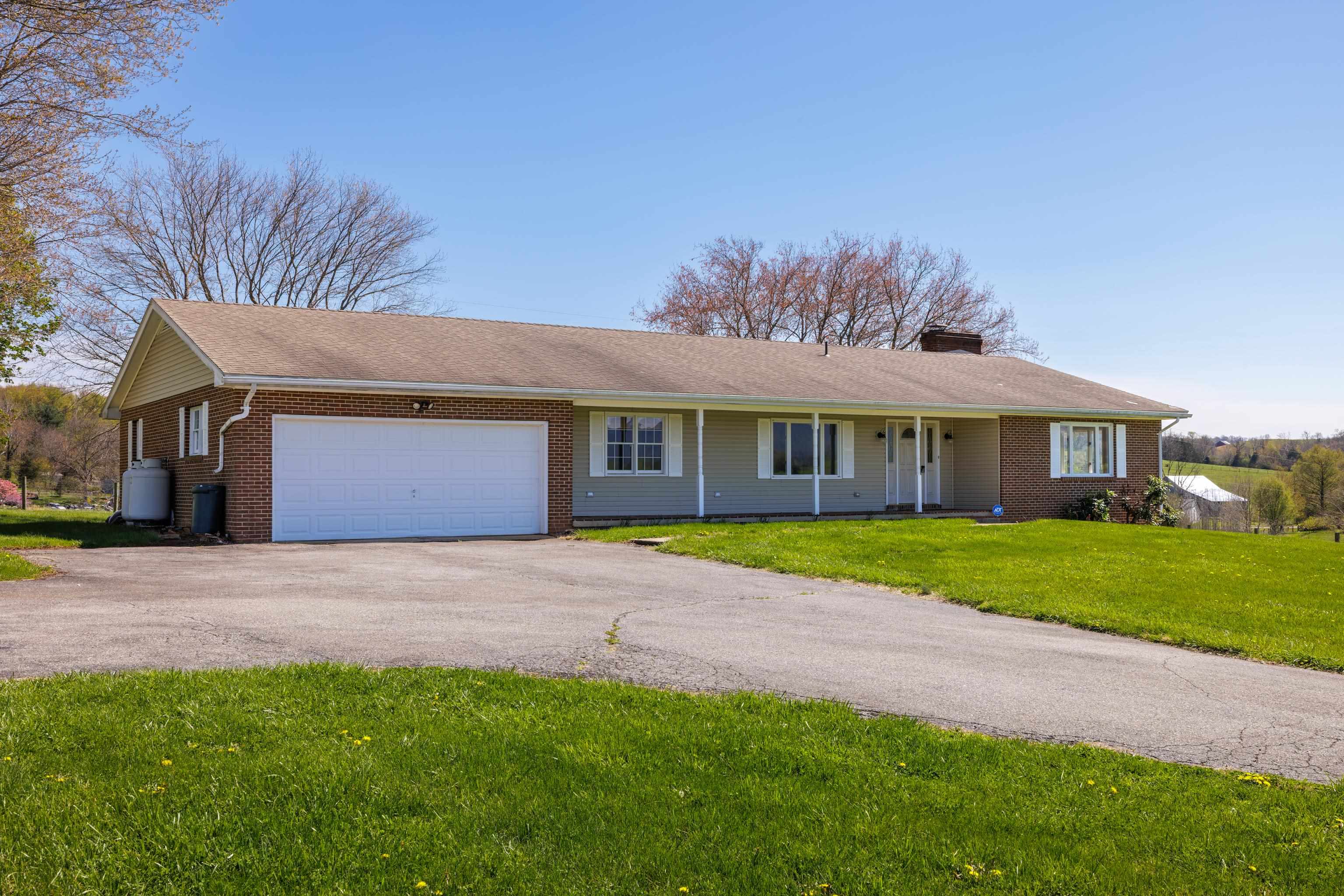 2834 Brownsburg Turnpike Raphine, VA 24472 - Photo 6 of 69 a front view of a house with a yard and garage