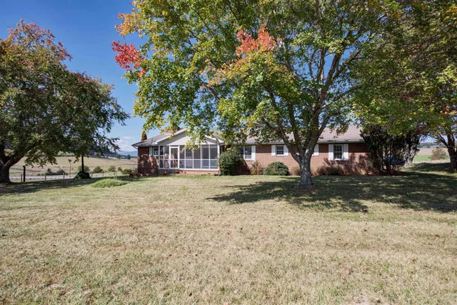 a view of a house with a tree in the yard