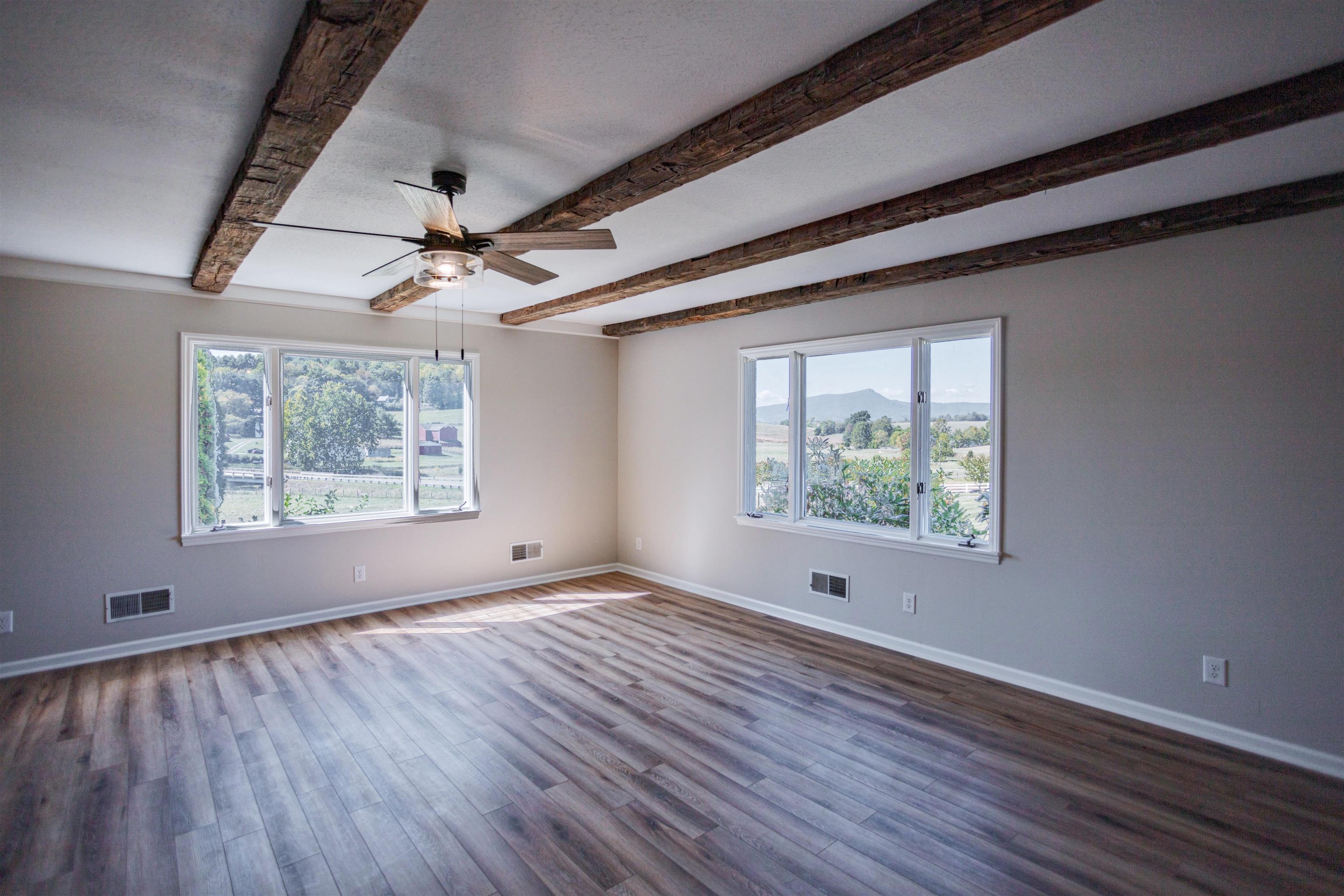 2834 Brownsburg Turnpike Raphine, VA 24472 - Photo 10 of 69 a view of an empty room with wooden floor and a window