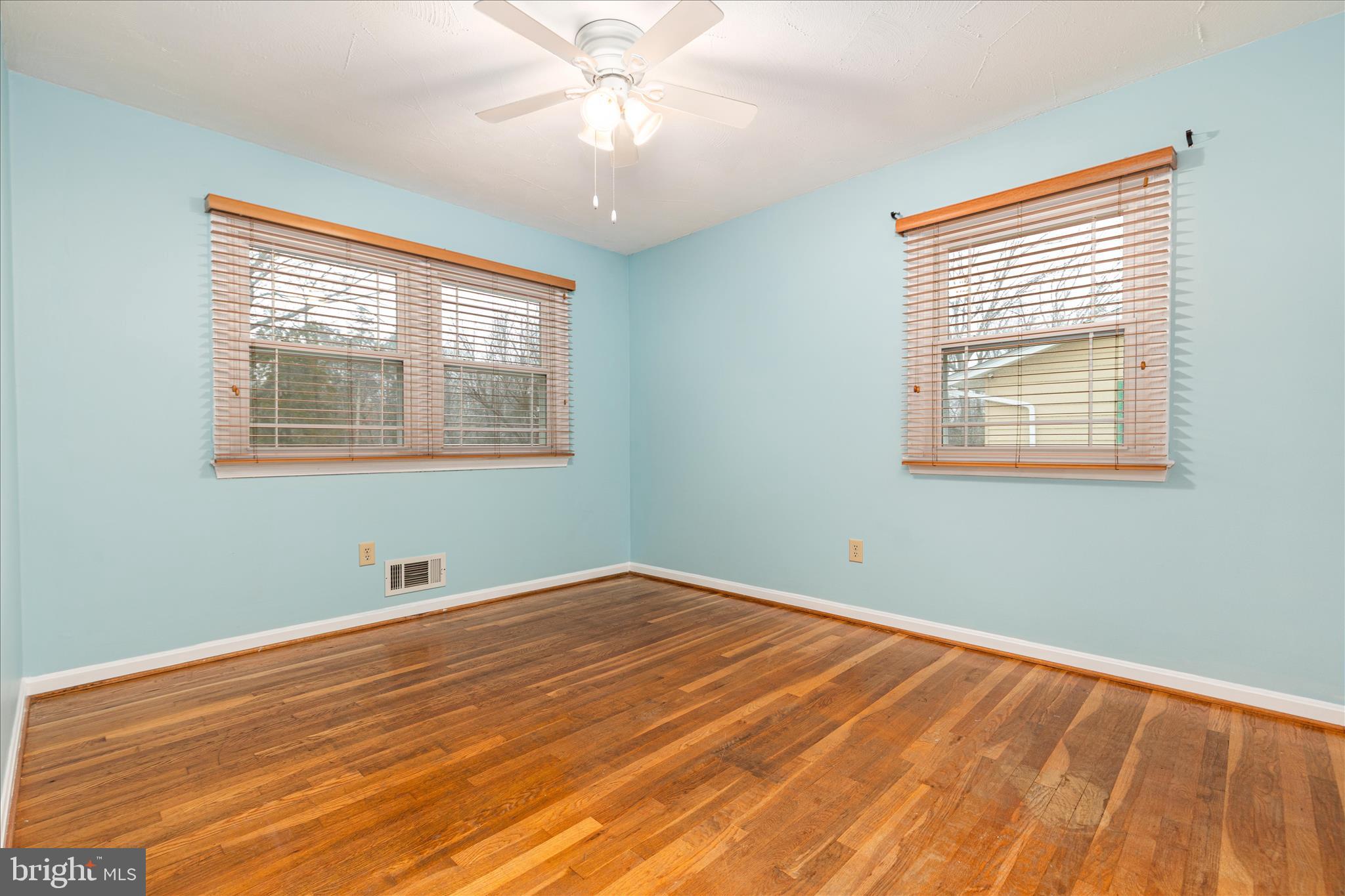 7398 Roxbury Avenue Manassas, VA 20109 - Photo 21 of 75 a view of an empty room with wooden floor and a window