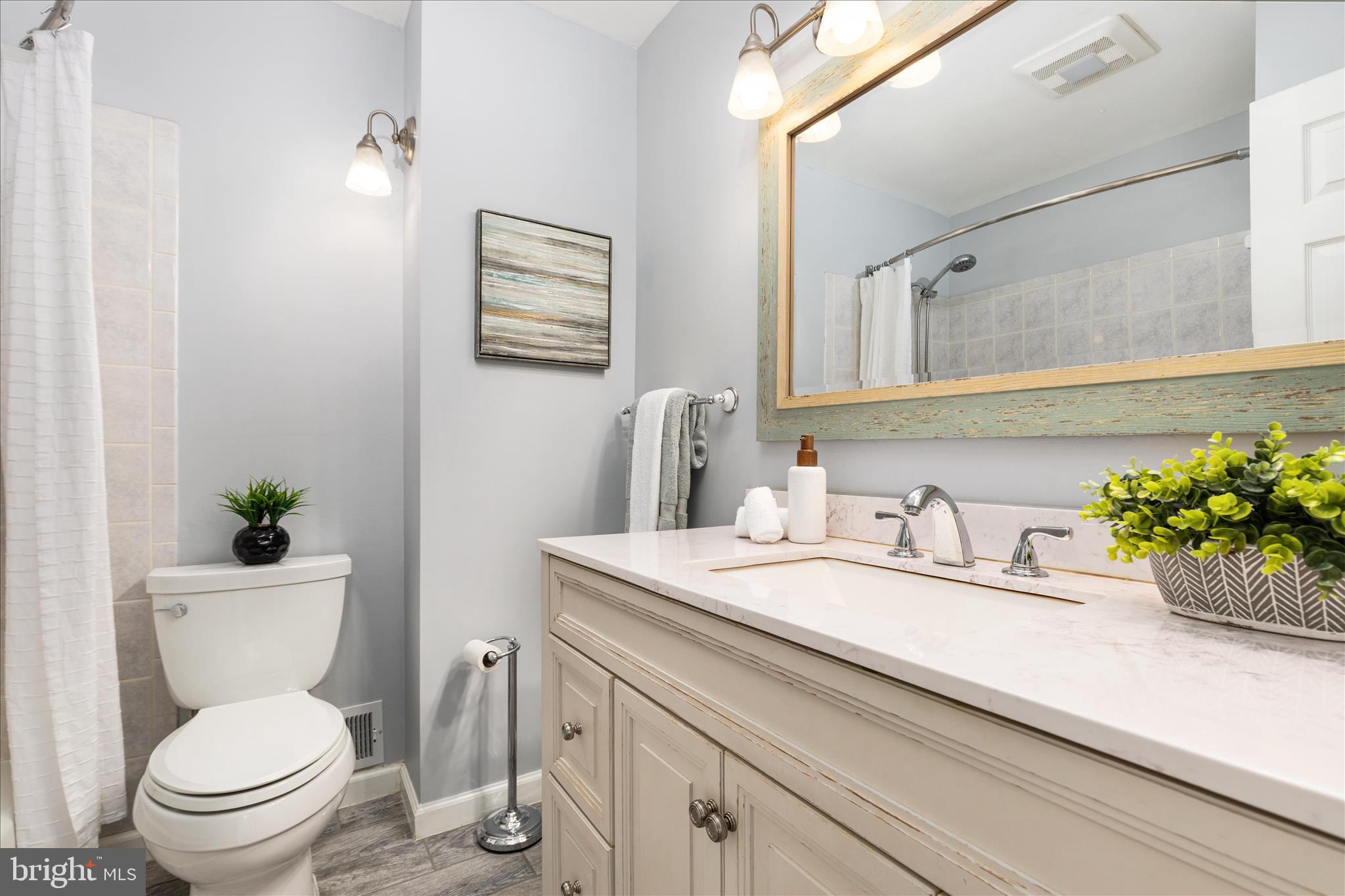 7398 Roxbury Avenue Manassas, VA 20109 - Photo 23 of 75 a bathroom with a granite countertop toilet sink and mirror