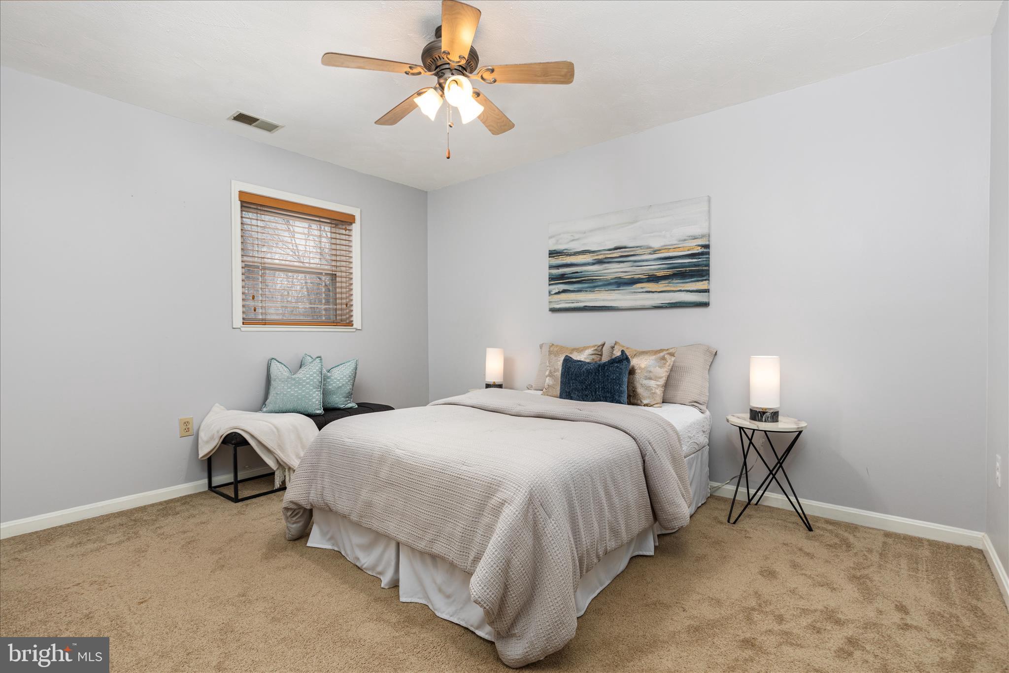 7398 Roxbury Avenue Manassas, VA 20109 - Photo 29 of 75 a bedroom with bed and a chandelier