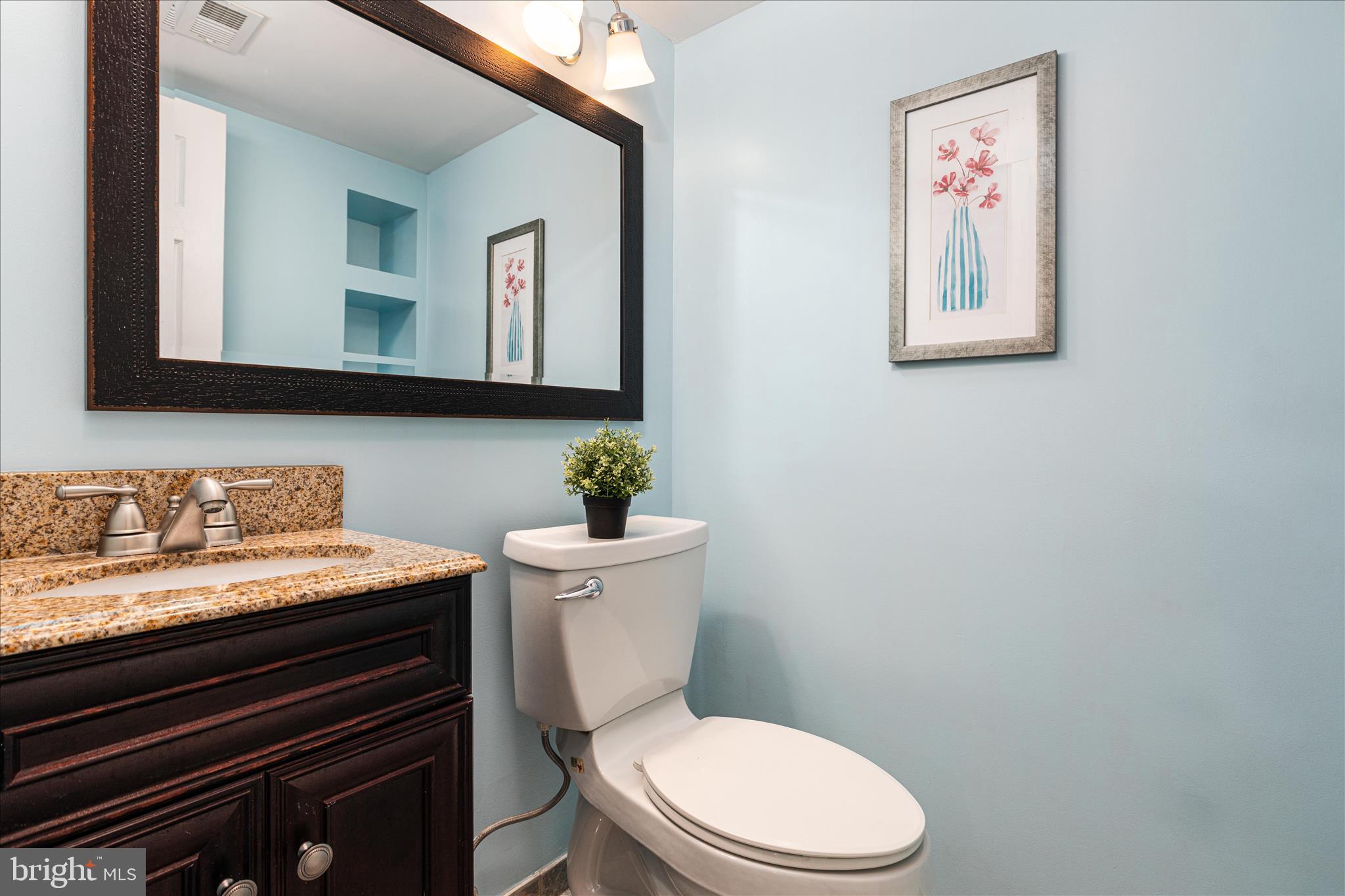 7398 Roxbury Avenue Manassas, VA 20109 - Photo 30 of 75 a bathroom with a granite countertop toilet sink and mirror
