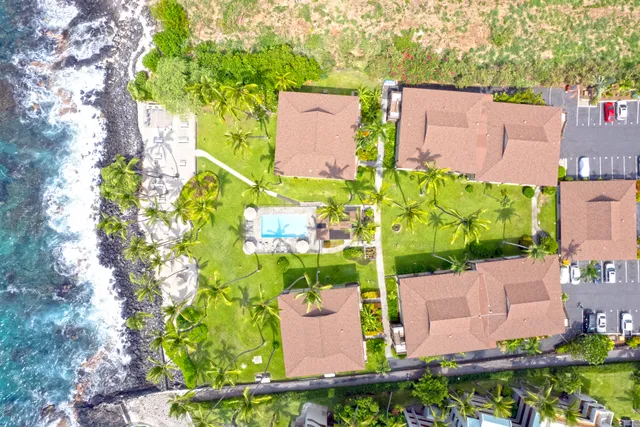 an aerial view of a house with a yard and garden space