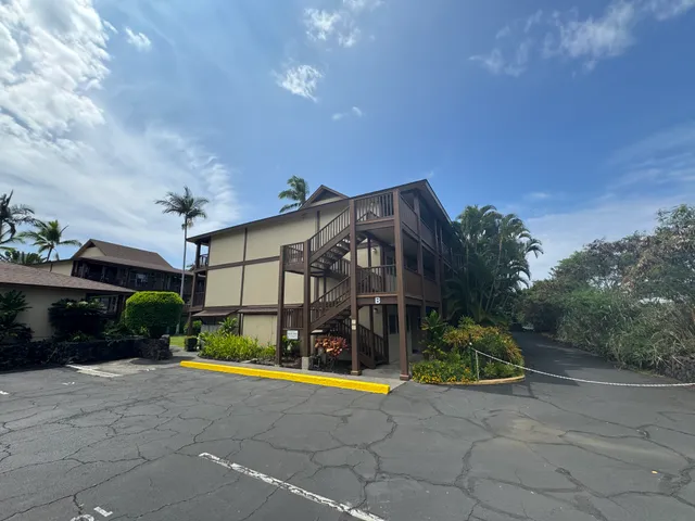 a view of a house with backyard and a patio