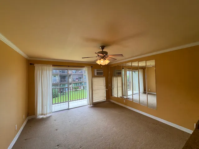 a view of a livingroom with a ceiling fan and window