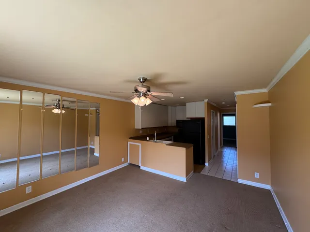 a view of a room with a kitchen