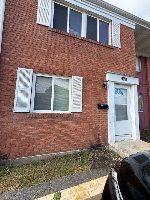 1351 Monomoy Street, Unit D Aurora, IL 60506 - Photo 1 of 14 a brick house that has a small yard