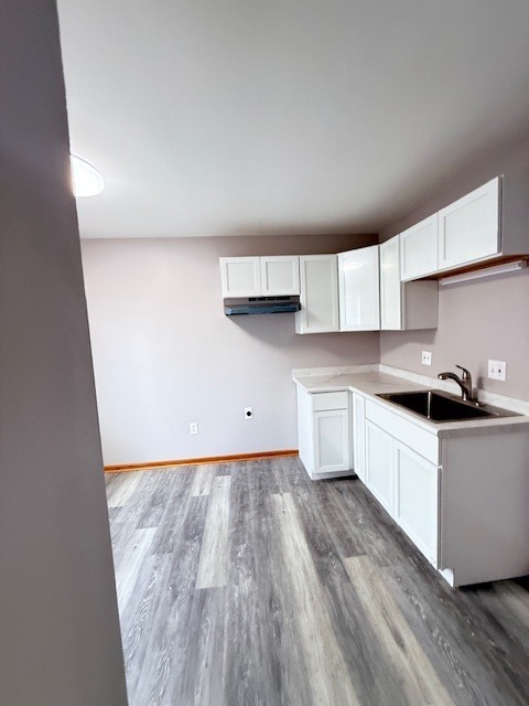 1351 Monomoy Street, Unit D Aurora, IL 60506 - Photo 5 of 14 a kitchen with granite countertop white cabinets and white appliances